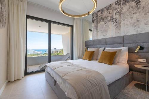 a bedroom with a large bed and a large window at EL Eden casa 71 in Málaga