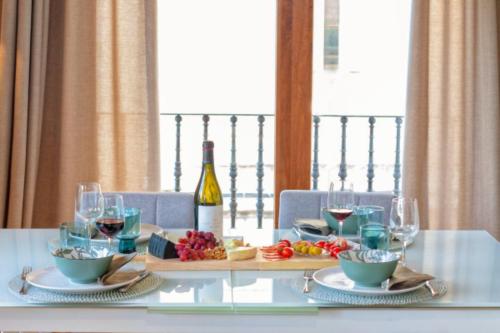 a dining table with wine glasses and food on it at Apartamento Sant Pere II in Benissa