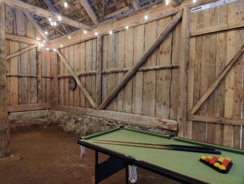 a ping pong table in a room with wooden walls at Nigula Country Home in Leie