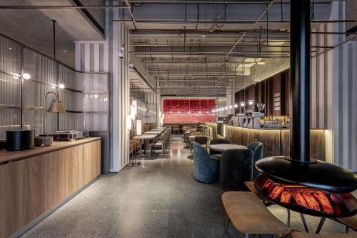 a restaurant with tables and chairs in a room at NOA Hotel Shanghai- Jing'an Temple in Shanghai