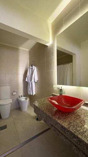a bathroom with a red bath tub on a counter at HOTEL COLL OFICIAL - BRAGADO Provincia de Bs As in Bragado