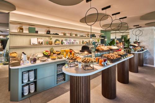 a bakery with many different types of food on display at Ibis Styles Madrid Airport Valdebebas in Madrid