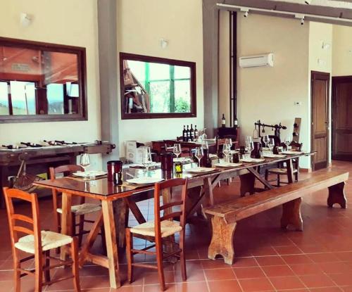 a large wooden table with chairs in a room at Agriturismo Bruscola in San Casciano in Val di Pesa