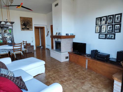 a living room with a couch and a fireplace at Casa Marina in La Posta