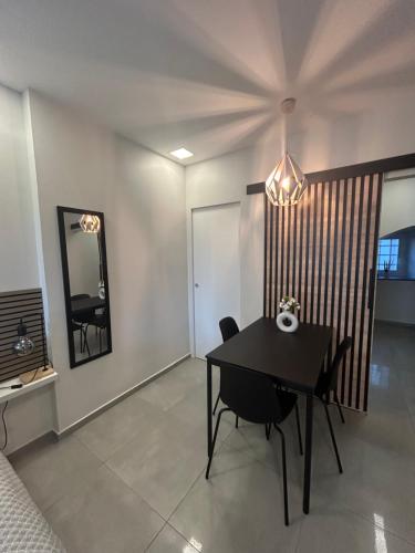 a dining room with a table and a mirror at Apartma Darsi in Ajdovščina