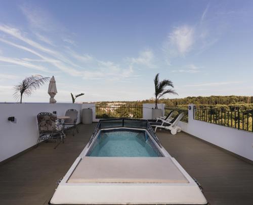 a swimming pool on the balcony of a house at St Nicholas Tsilivi Apts in Planos