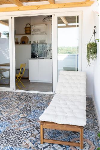 a living room with a white couch on a rug at Vico Larzio 6 "Terrazza sul Vico" in Noto