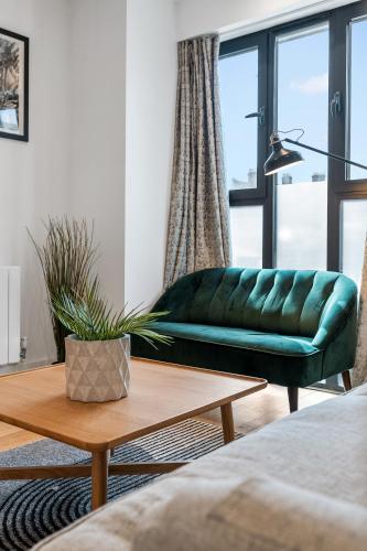 a living room with a green couch and a coffee table at Bright and Modern 3 bed Seaside escape sleeps 5 in Brighton & Hove
