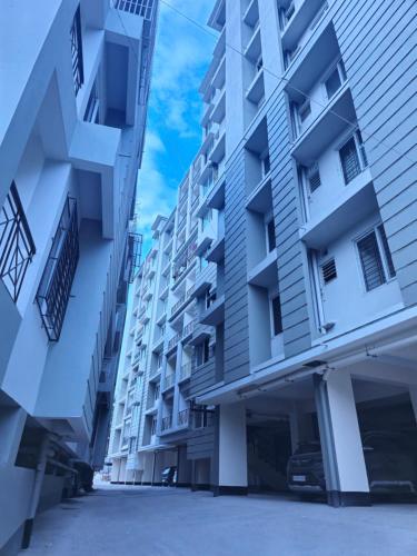 an empty street between two tall buildings at Amaar Ghar in Guwahati