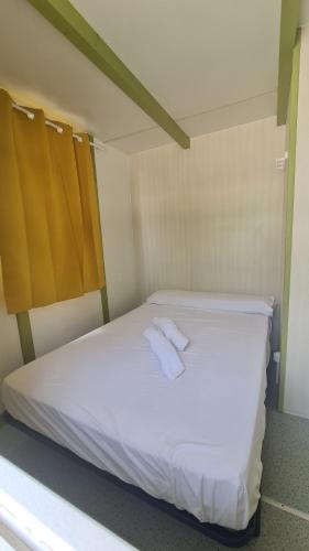 a bed with two towels on it in a room at Camping Costa Blanca in El Campello