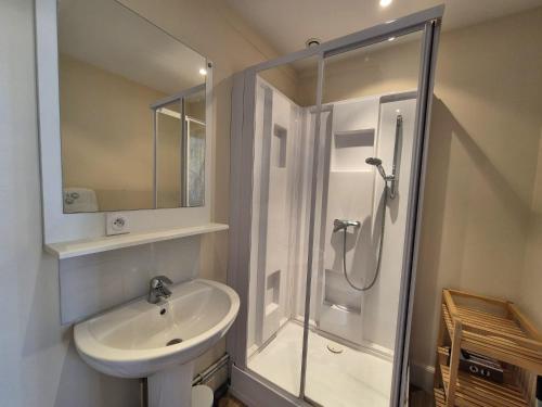 a white bathroom with a shower and a sink at Les Loges Du Beffroi - La Cloche Dorée & Parking privé in Arras