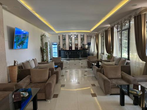 a large living room with couches and tables at Ani Resort in Artavaz