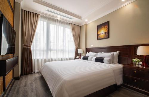 Lotusama Central Hanoi Hotelにあるベッド