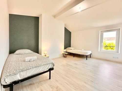 Giường trong phòng chung tại L'Orangerie Urbaine central