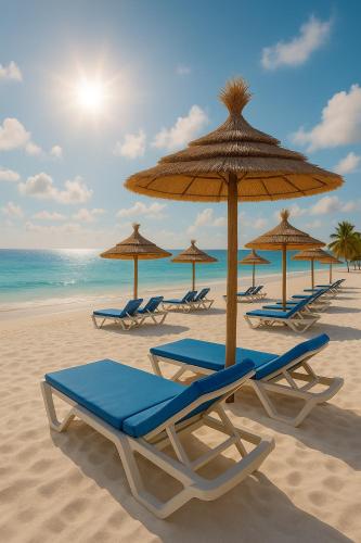 a group of chairs and umbrellas on a beach at Sousse Pearl Marriott Resort & Spa in Sousse