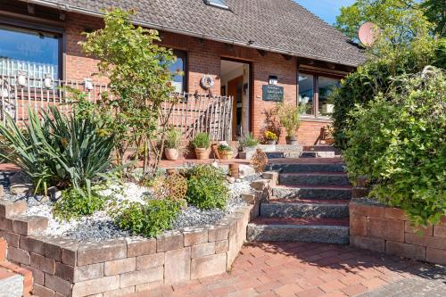 a brick building with stairs and plants in front of it at Ferienhaus Ankerglück in Lensahn