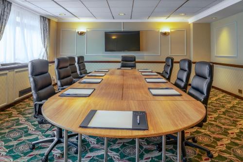 a conference room with a large wooden table and chairs at Grand Hotel Blackpool in Blackpool