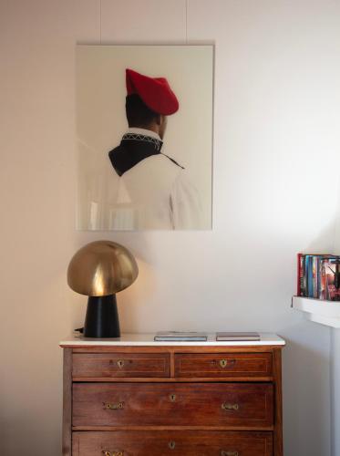 a picture of a man in a red hat on a dresser at Can Arabí - Adults Only in Ibiza Town