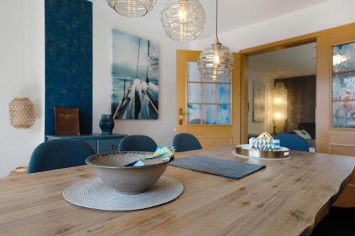 a dining room table with a bowl on top of it at Ferienhaus Ankerglück in Lensahn
