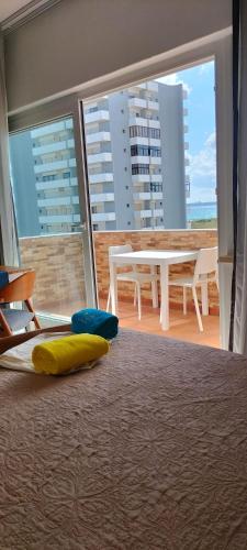 a bed with a yellow and blue pillow on the floor at Sol e Praia Alvor 1 in Alvor