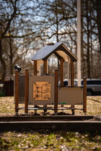a small park with a playground equipment in the grass at Tranås Vandrarhem in Tranås