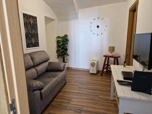 a living room with a couch and a table at Casa do Barão in Évora