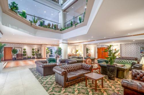 an open living room with leather furniture and a large skylight at Grand Hotel Blackpool in Blackpool