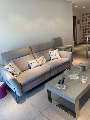 un salon avec un canapé et une table dans l'établissement Centre Capitou avec jardin et piscine, à Mandelieu-la-Napoule