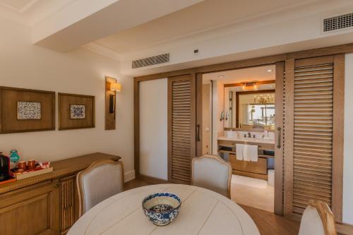 a dining room with a table and a bathroom at Allium Bodrum Resort & Spa in Yalıkavak