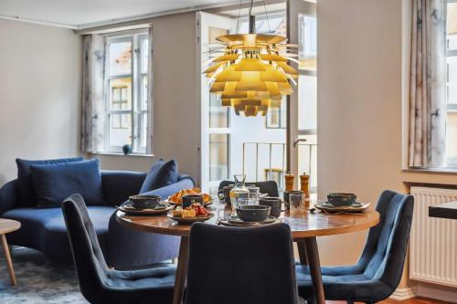 a dining room with a table and blue chairs at Prime Location - Near Nyhavn & Tivoli Gardens in Copenhagen