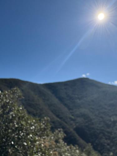 a view of a mountain with the sun in the sky at petit T2 RDC tout confort in Amélie-les-Bains-Palalda