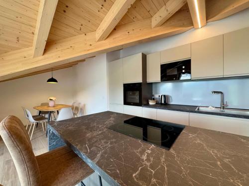 a kitchen with a counter top and a table at Mountain Lodge in San Lorenzo in Banale