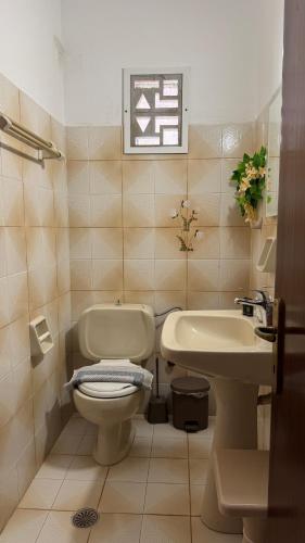 a bathroom with a toilet and a sink at Kassiopi Apartmets4you III in Kassiopi