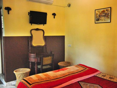 a bedroom with a bed and a guitar on the wall at Sajhome Fortkochi, Kochi, Kerala, inda in Cochin