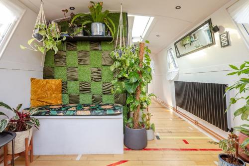 a room with plants on the wall and a bench at The Floating Terrarium in London