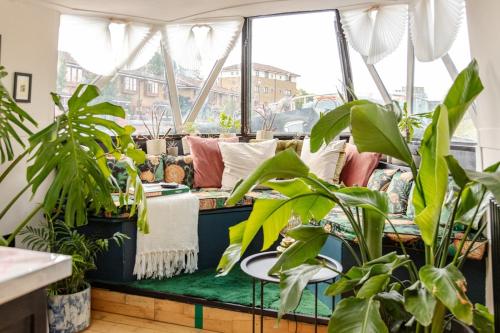 a living room filled with lots of plants at The Floating Terrarium in London