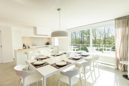 a kitchen and dining room with a table and chairs at Zeesamen 5 min from beach in Cadzand