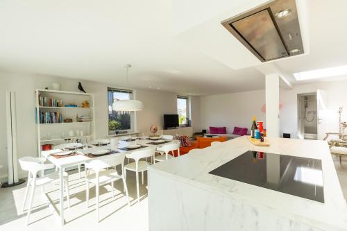 a kitchen and living room with a table and chairs at Zeesamen 5 min from beach in Cadzand