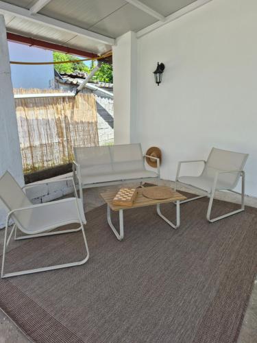 a living room with a couch and chairs and a table at Villa Aspri in Nea Kalikratia