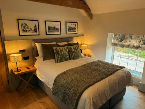 a bedroom with a large bed and a window at Rooms at The Vine Tree in Crickhowell