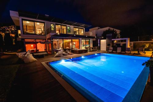 a large swimming pool in front of a house at night at Villa Cary in Funchal