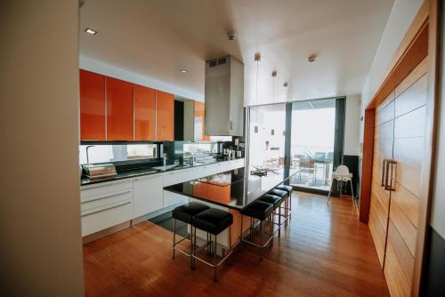 a kitchen with a counter with stools in it at Villa Cary in Funchal