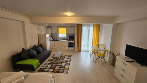 a living room with a couch and a table at Airport Residence in Otopeni