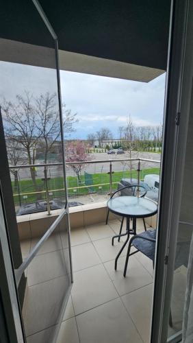 a balcony with a table and a view of a field at Airport Residence in Otopeni