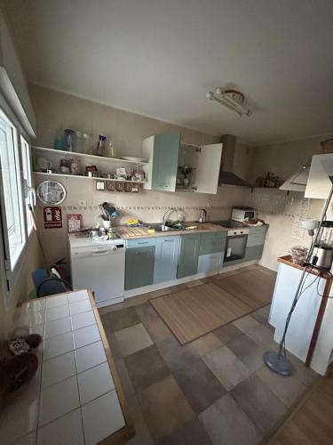 a kitchen with green cabinets and white appliances at La Casita Azul in Cáseda
