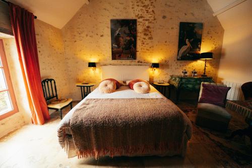 a bedroom with a bed with two pillows on it at La Maison d'Horbé in La Perrière