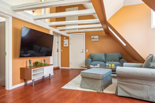 a living room with a couch and a tv at Most Central Location - By Tivoli Nyhavn & Metro in Copenhagen