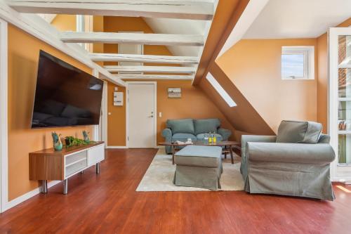 a living room with a large flat screen tv at Most Central Location - By Tivoli Nyhavn & Metro in Copenhagen