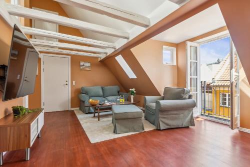 a living room with a couch and a tv at Most Central Location - By Tivoli Nyhavn & Metro in Copenhagen