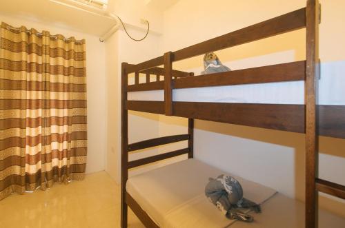 two bunk beds in a room with a curtain at Stay Manila Hotel by RedDoorz in Manila